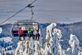 Poiana Brasov, Romania -09 January 2019: Skiers on the ski lift, skiers on slope in Romanian ski resort in sunny day, Poiana