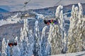 Poiana Brasov, Romania -09 January 2019: Skiers on the ski lift, skiers on slope in Romanian ski resort in sunny day, Poiana