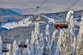 Poiana Brasov, Romania -09 January 2019: Skiers on the ski lift, skiers on slope in Romanian ski resort in sunny day, Poiana