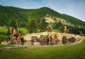 Poiana lui Caliman Park in Caciulata, Romania. Artesian well with horse statues.