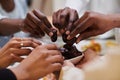 In a poignant close-up, the diverse hands of a Muslim family delicately grasp fresh dates, symbolizing the breaking of