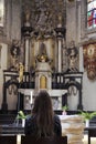 Solemn Prayer at an Ornate Church Altar