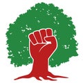 Concept of the fight against deforestation of the planet with a raised fist in front of a tree.