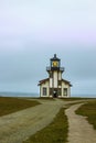 Point Cabrillo Lighthouse north of Mendicino California with tourists walking around and looking out over the ocean on a foggy day Royalty Free Stock Photo