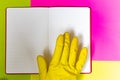 Point gloved finger to a blank magazine page. Bright pink and yellow background. hazard