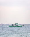 The Captain Al, a charter wreck fishing boat, sailing back to shore with Long Beach Long Island in the background