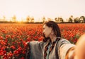 Point of view of beautiful woman making selfie in flower field.