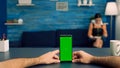 Point of view freelencer man in office studio holding mock up green screen chroma key phone