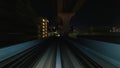 Point of view hyperlapse time-lapse of fast train travel forward on Yurikamome train line at night in Odaiba Tokyo, Japan