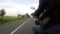 The point of view of a motorcycle rider on a rural road in thailand