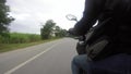The point of view of a motorcycle rider on a rural road in thailand