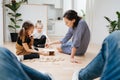 Point of view photo. Father looks how mom and kids playing with wooden blocks