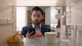 Point of view POV inside refrigerator Caucasian businessman employer man open fridge empty shelves with one egg and Royalty Free Stock Photo