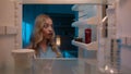 Point of view POV inside refrigerator Caucasian girl hungry woman open fridge at home kitchen look at empty shelves Royalty Free Stock Photo