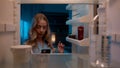 Point of view POV inside refrigerator Caucasian girl hungry woman open fridge at home kitchen look at empty shelves Royalty Free Stock Photo