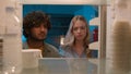 Point of view POV inside refrigerator Caucasian girl woman girlfriend wife and Arabian man Indian guy boyfriend husband Royalty Free Stock Photo