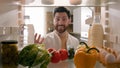 Point of view POV inside refrigerator happy excited hungry Caucasian man open fridge full of healthy vegetables many