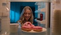 Point of view POV from inside refrigerator hungry Caucasian woman girl at night evening kitchen open fridge take out Royalty Free Stock Photo