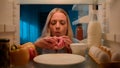 Point of view POV from inside refrigerator hungry Caucasian woman girl at night evening kitchen open fridge take out Royalty Free Stock Photo