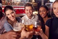 Point Of View Shot Of Male And Female Friends Making A Toast As They Meet For Drinks In Bar