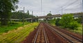 Point of view train travel under cloudy sky