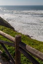 Point of view way on ocean coast with wooden fence.