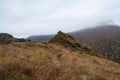 Pointed cliff, a misty mountainside. Ghost rocks. Awesome scenic mountain landscape with big cracked pointed stones closeup in