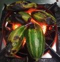 pointed gourd being charred over flame Royalty Free Stock Photo