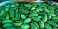 pointed gourd fresh green beans with water into the tub at vegetable shop Royalty Free Stock Photo
