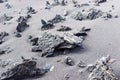 Pointed stones on gray sand Royalty Free Stock Photo