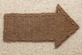 Pointer of burlap lies on rice grain Royalty Free Stock Photo