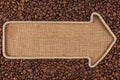 Pointer made from rope with coffee beans lying on sackcloth Royalty Free Stock Photo