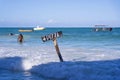 Pointer pizza on a wooden post in sea water on the tropical beach of Zanzibar island, Tanzania, Africa. Travel and vacation Royalty Free Stock Photo