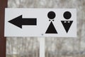 A pointer to a public toilet and the sign of a man and a woman. Hygiene in the Park, outdoor