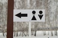 A pointer to a public toilet and the sign of a man and a woman. Hygiene in the Park, outdoor