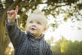 Pointing Adorable Blonde Baby Boy Outdoors at the Park