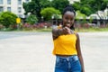 Pointing african american young adult woman with braids Royalty Free Stock Photo