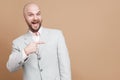 Pointing finger and happy portrait of handsome middle aged businessman in classic light gray suit standing, looking Royalty Free Stock Photo