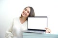 Pointing laptop screen, portrait of caucasian woman pointing laptop screen. Woman holding modern laptop with empty blank Royalty Free Stock Photo