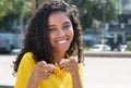 Pointing latin american girl with long dark hair