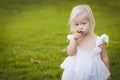 Pointing Little Girl Wearing White Dress In A Grass Field Royalty Free Stock Photo