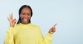 Pointing, portrait and black woman with opportunity, ok sign and announcement on a blue studio background. African