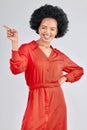 Pointing, portrait and black woman with a smile, promotion and presentation against a white studio background. Happy