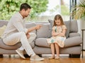 Pointing, scold and father with child on a sofa in the living room for naughty behavior at home. Upset, angry and young Royalty Free Stock Photo