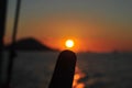 pointing the sun with a finger at a very beautiful sunset. Beautiful Sunset in tropical Komodo island, Labuan Bajo, Fores,