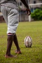 POINTNOIRE/CONGO - 18MAY2013 - African boy walking towards rugby ball