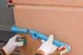 Plumber hand weld blue plastic water pipe by using glue sealant