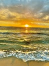 Poipu Sunset Serenade: Turquoise Waters, Foamy Surf, and Surfer\'s Dance Royalty Free Stock Photo