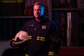 Poirtrait of fireman looking to side near fire truck Royalty Free Stock Photo