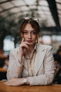 Professional young woman in a business setting, thoughtful and confident Royalty Free Stock Photo